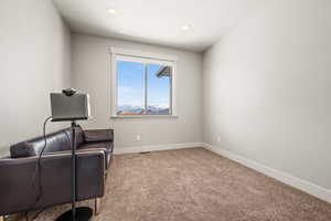 Living area with light colored carpet