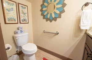 Bathroom featuring tile patterned flooring, vanity, and toilet