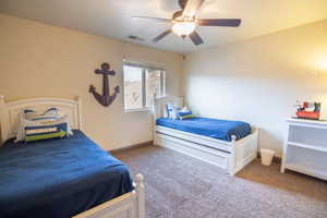 Bedroom with ceiling fan and carpet flooring