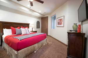 Bedroom featuring ceiling fan and carpet floors