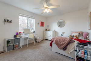 Carpeted bedroom with ceiling fan