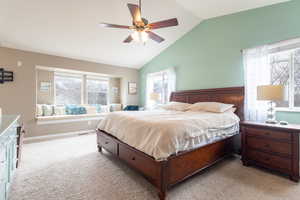 Bedroom featuring ceiling fan, lofted ceiling, and light carpet