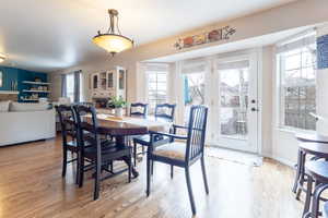 Dining area with plenty of natural light and light wood-type flooring