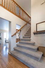 Staircase featuring wood-type flooring