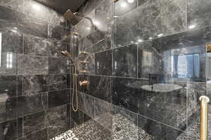 Room details featuring a tile shower