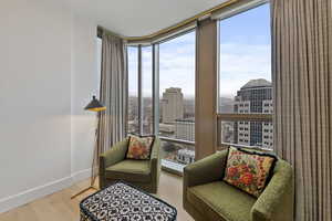 Sitting room featuring a wall of windows and hardwood / wood-style floors