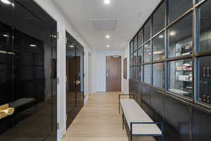 Hallway with light hardwood / wood-style flooring