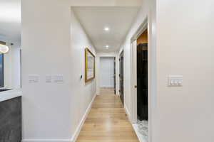 Hallway with light hardwood / wood-style flooring