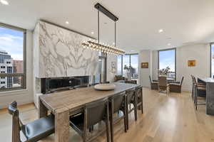 Dining area featuring a premium fireplace and light hardwood / wood-style floors