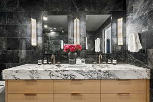 Bathroom with vanity and backsplash