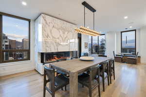 Dining area featuring a premium fireplace and light wood-type flooring