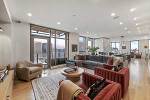 Living room featuring expansive windows and light hardwood / wood-style flooring