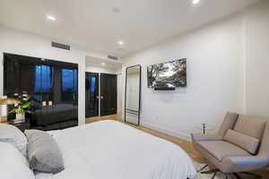 Bedroom with light hardwood / wood-style flooring