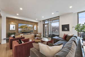 Living room featuring light hardwood / wood-style flooring and floor to ceiling windows