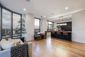 Living room featuring a wall of windows and light wood-type flooring