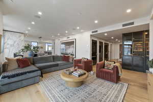 Living room with light hardwood / wood-style floors