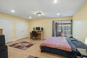 Bedroom with hardwood / wood-style flooring and access to exterior