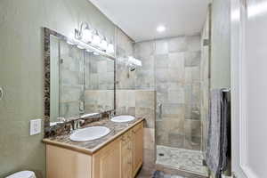 Bathroom featuring vanity and a shower with shower door