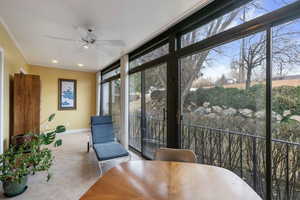 Sunroom / solarium with ceiling fan and a wealth of natural light