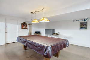 Rec room with billiards and concrete floors