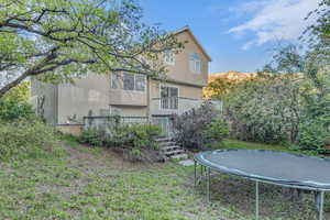 Exterior space featuring a trampoline and a deck