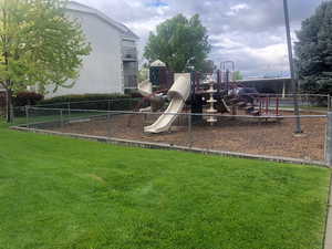 View of jungle gym with a lawn