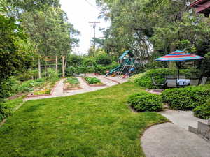 Summer View of yard featuring a playground