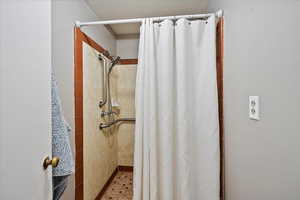 Bathroom featuring a shower with curtain