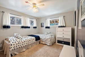 Bedroom featuring light carpet and ceiling fan