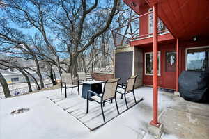 Snow covered patio featuring area for grilling