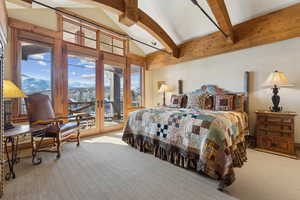 Bedroom with high vaulted ceiling, beam ceiling, access to outside, and light colored carpet