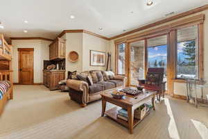 Carpeted living room featuring ornamental molding