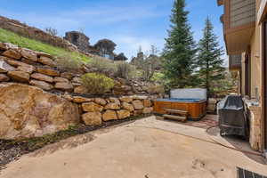 View of patio / terrace with a hot tub and area for grilling