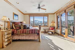 Bedroom with crown molding, a mountain view, access to outside, and carpet