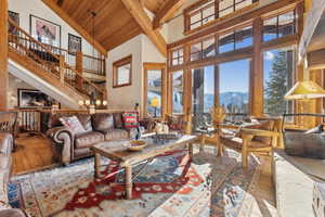 Living room with high vaulted ceiling, a mountain view, hardwood / wood-style floors, and wood ceiling