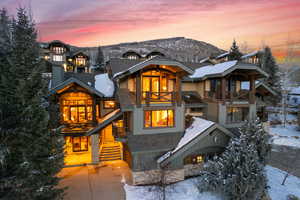 View of front of home with a balcony and a mountain view