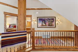 Interior space with vaulted ceiling and hardwood / wood-style floors