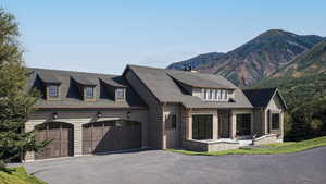 View of front facade featuring a garage and a mountain view