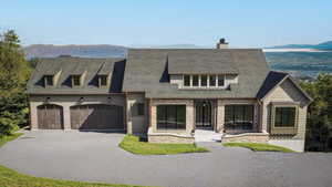 View of front facade with a garage and a mountain view