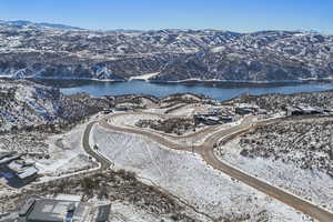 Snowy aerial view with a water and mountain view