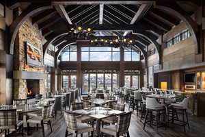 Dining room featuring an inviting chandelier and vaulted ceiling with beams