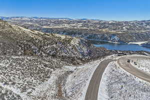 Snowy aerial view with a water and mountain view