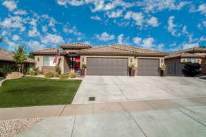 View of front of home featuring a garage and a front lawn