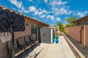 View of patio with a storage unit