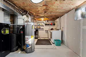 Basement featuring independent washer and dryer and water heater