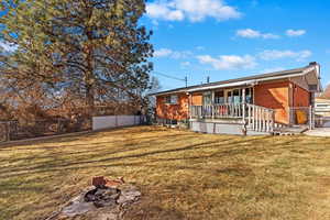 Rear view of house with a yard