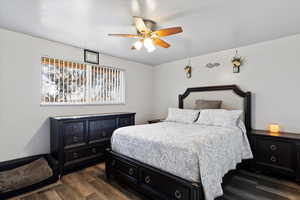 Bedroom featuring dark hardwood / wood-style flooring and ceiling fan