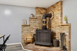 Interior details featuring hardwood / wood-style floors and a wood stove