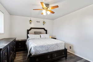 Bedroom featuring dark hardwood / wood-style floors and ceiling fan