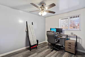 Home office featuring dark hardwood / wood-style floors and ceiling fan